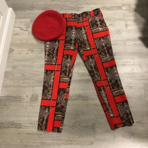 May include: Red and brown patterned pants with a red beret. The pants have a snake skin pattern and red stripes.