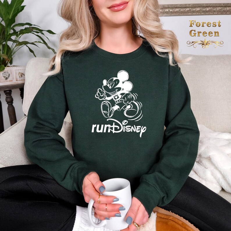 May include: A dark green sweatshirt with a white graphic of Mickey Mouse running and the text "runDisney".