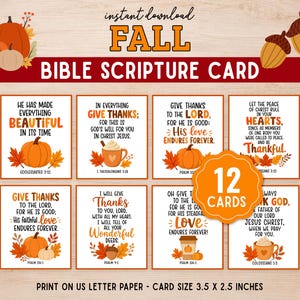 May include: A set of 12 autumn-themed Bible scripture cards featuring orange pumpkins, acorns, and seasonal leaves. Each card displays religious text and measures 8.89 by 6.35 cm. The design includes warm colours and illustrations on a light wood background.