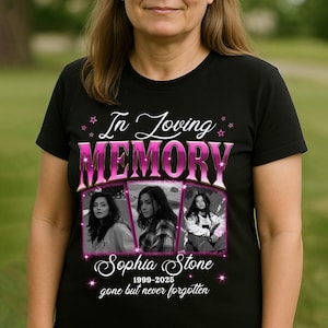 May include: Black t-shirt featuring a memorial design. The design includes the text "In Loving MEMORY" in pink, the name "Sophia Stone", and three black and white photos. The shirt also has the dates 1999-2025 and the phrase "gone but never forgotten".