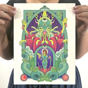 May include: A colorful art print featuring an alien deity with multiple eyes and tentacles, adorned in a red robe. The artwork includes a space-themed background, a female astronaut, and various green alien creatures. The style is reminiscent of vintage comic book art.