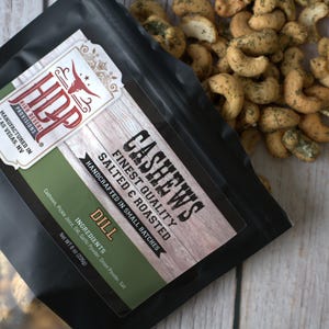 May include: A black pouch of High Desert Provisions dill flavored cashews with a label reading Cashews Finest Quality Salted & Roasted Handcrafted in Small Batches Dill Ingredients Cashews, Pickle Juice, Dill, Garlic Powder, Onion Powder, Salt Net Wt 8 oz (226g).