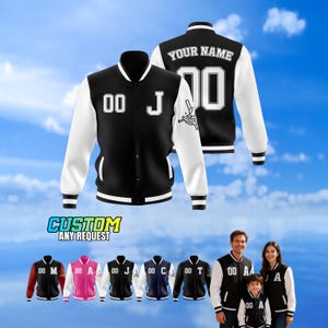May include: Black and white varsity jacket with the text "YOUR NAME" and "00" on the back. The front of the jacket has the number "00" and the letter "J". The image also shows other jacket color options and the text "CUSTOM ANY REQUEST".