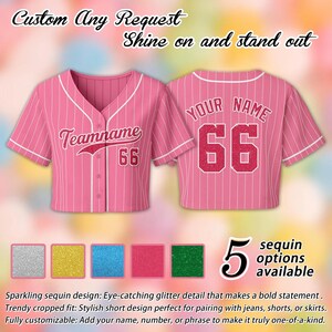 May include: Pink cropped baseball jersey with white pinstripes and accents. Features the text "Teamname" and the number "66" on the front, and "YOUR NAME" and "66" on the back. Includes text "Custom Any Request Shine on and stand out". Five sequin color options are available.