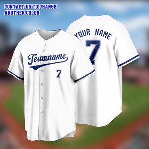 May include: White baseball jersey with navy blue accents. The jersey features the text "Teamname" and the number "7" on the front, and "YOUR NAME" and the number "7" on the back. The text "CONTACT US TO CHANGE ANOTHER COLOR" is at the top.