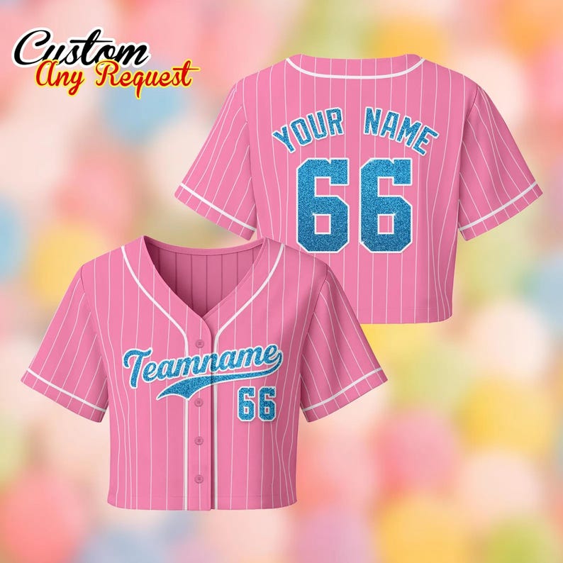 May include: Pink baseball jersey with white pinstripes and white trim. The front features the text "Teamname" and the number "66" in blue glitter. The back of the jersey has the text "YOUR NAME" and the number "66" in blue glitter. The top left corner has the text "Custom Any Request".