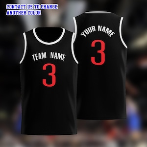 May include: Black basketball jersey with white trim and the text "TEAM NAME" and the number "3" in red on the front. The back of the jersey displays "YOUR NAME" and the number "3" in red. The text "CONTACT US TO CHANGE ANOTHER COLOR" is at the top.