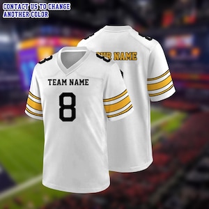 May include: A white football jersey featuring black text that reads TEAM NAME and the number 8 on the front, with yellow and black stripes on the sleeves. The back displays the text YOUR NAME. Text at the top reads CONTACT US TO CHANGE ANOTHER COLOR.