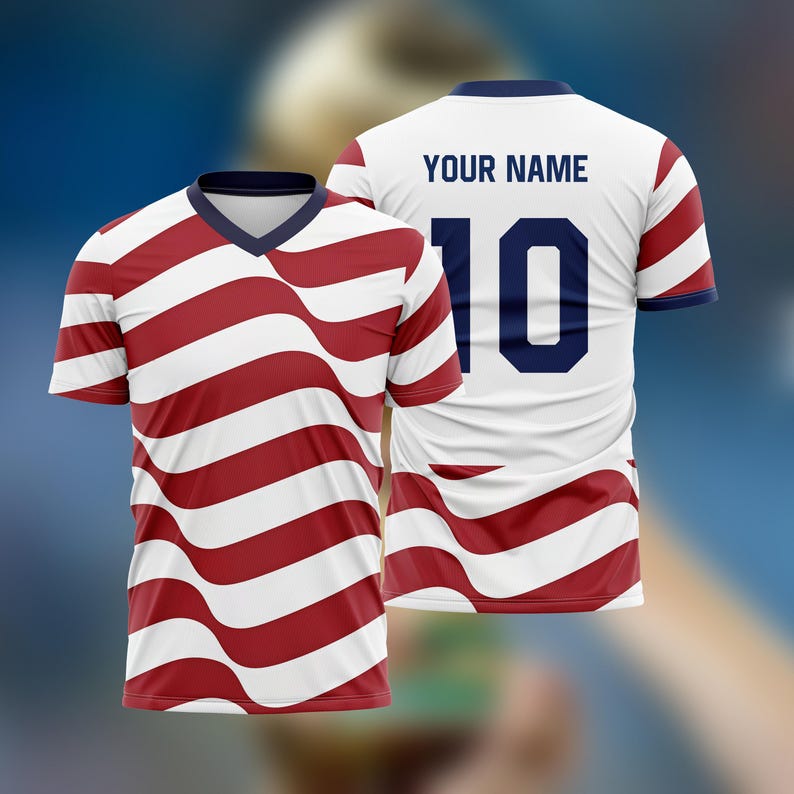 May include: A white and red striped soccer jersey with a V-neck collar. The jersey has the number 10 on the back, along with the text "YOUR NAME". The stripes have a wavy design.