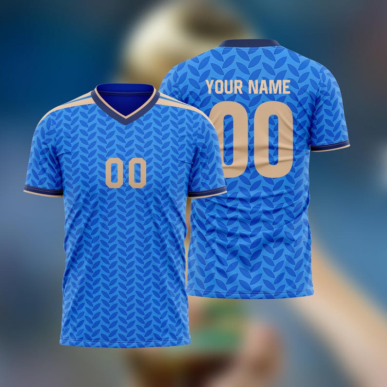 May include: Blue jersey with a leaf pattern, featuring the number "00" in gold on the front and back. The back also displays "YOUR NAME". The jersey has a V-neck and gold trim.