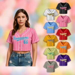 May include: A woman wearing a pink baseball jersey with white vertical stripes, the text "Teamname 66" in blue, and a button-up front. Nine other baseball jerseys in various colors are displayed, including black, white, pink, blue, yellow, red, orange, green, and purple.