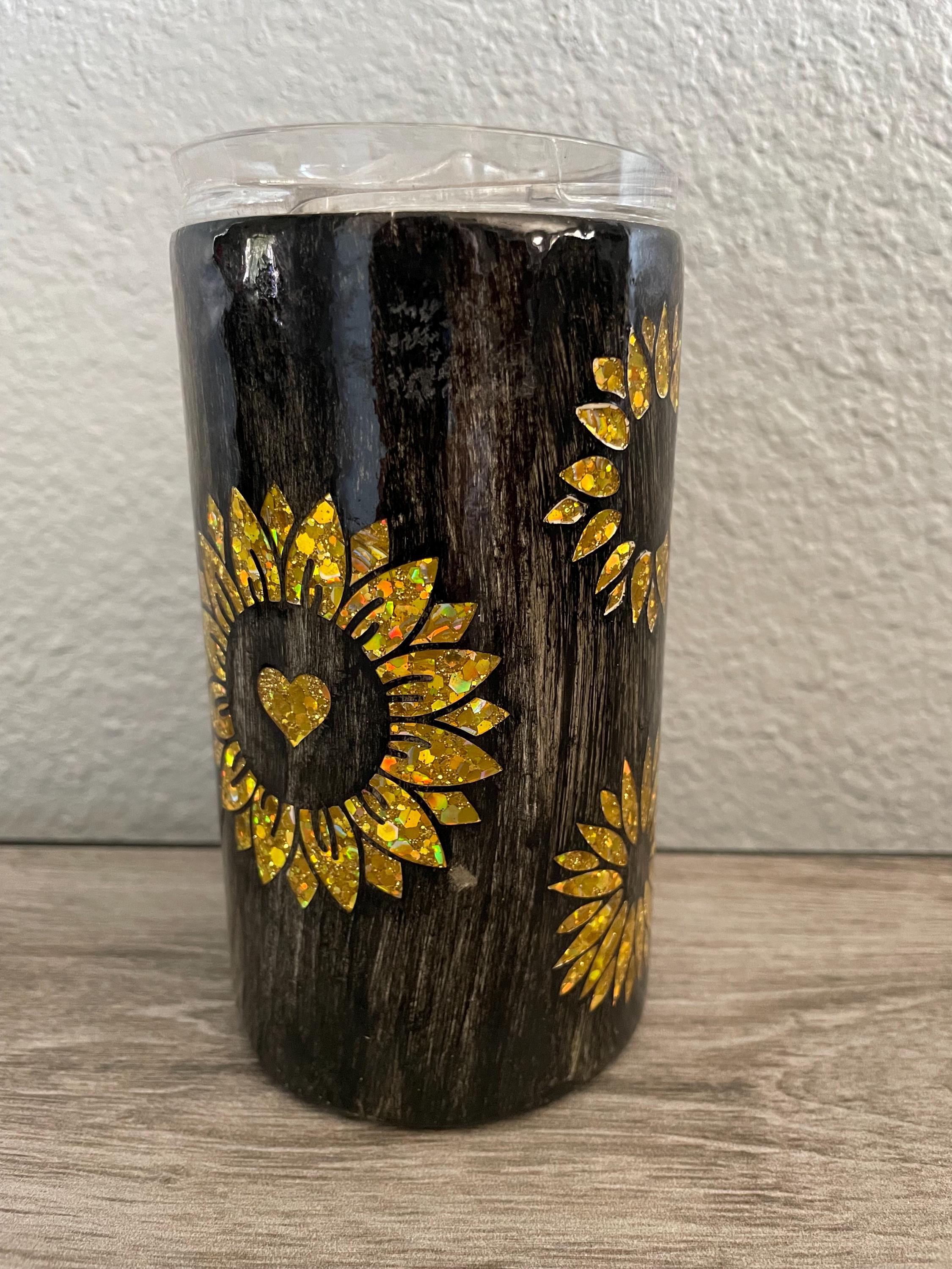 16oz stainless steel tumbler, with yellow glitter sunflowers and black wood grain, epoxy coated finish.