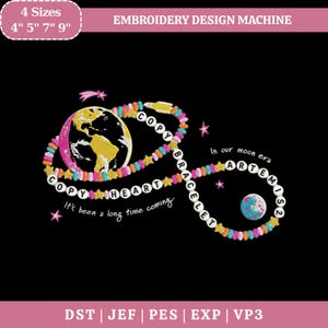 May include: An embroidery design on a black background. The design features a colorful bracelet with the words "COPY HEART BRACELET" and "In our moon era ARTEMIS2". A globe and a small planet are also included. The text "It's been a long time coming" is also present.