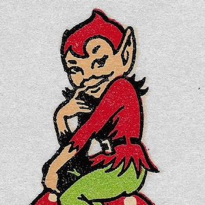 Puede incluir: Ilustración vintage de una figura de elfo travieso. El elfo, con un atuendo rojo y pantalones verdes, está posado sobre una seta roja con lunares blancos. La obra de arte está sobre un fondo blanco con hierba verde en la parte inferior.