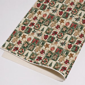 May include: A rectangular sheet of fabric featuring a repeating grid pattern of holiday-themed illustrations. The design includes gingerbread people, red poinsettias, striped ornaments, green pine trees, candles, and bows on a cream background.