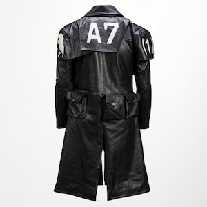 Peut inclure: Manteau en cuir noir avec plusieurs poches et un design unique. Le manteau porte le numéro "A7" en blanc au dos et un motif blanc sur l'épaule gauche. Le manteau a une silhouette longue et distinctive.