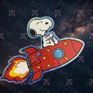 May include: A sticker featuring Snoopy from Peanuts, riding a red rocket ship through space. The rocket has yellow stars and a planet graphic. The background is a starry night sky.