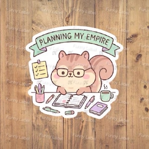 May include: A sticker featuring a cartoon squirrel wearing glasses and planning. The squirrel is surrounded by pens, a notebook, and a to-do list. The banner above the squirrel reads "PLANNING MY EMPIRE".