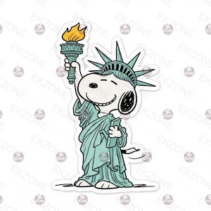 May include: A sticker featuring Snoopy as the Statue of Liberty. Snoopy is depicted in a light blue robe and crown, holding a torch with a yellow flame. The sticker has a white border and the background is white.