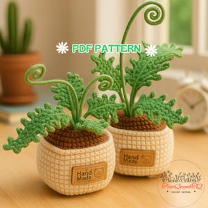 May include: Two crochet plant pots with green leaves and curly stems. The pots are beige with brown soil and a "Hand Made" label. The text "PDF PATTERN" is displayed above the plants.