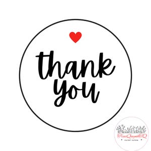 May include: A white circular sticker with a black border features the words "thank you" in a handwritten style, with a red heart above the word "you". A small logo with floral elements is in the bottom right corner.