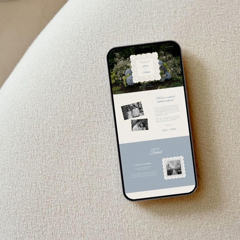 May include: A smartphone displaying a digital wedding invitation on its screen. The interface features a floral background, two black and white photographs of a couple, and text sections including Venue Details and St. Mary's Cathedral.