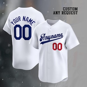May include: Two white baseball jerseys with button-down fronts. The back jersey features blue text reading YOUR NAME and the number 00. The front jersey displays blue script text reading Anyname and the red number 00. Text reads CUSTOM ANY REQUEST.