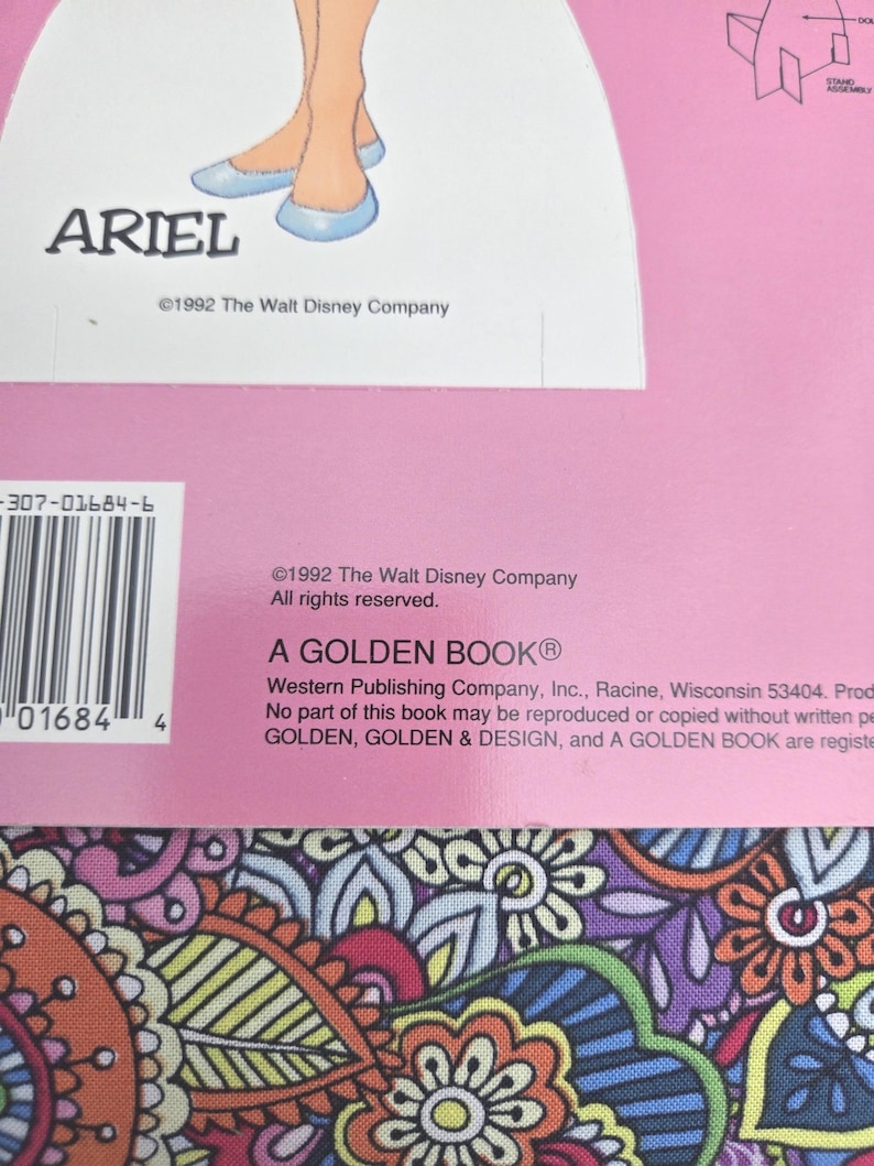 May include: A vintage Golden Book with a pink cover, featuring Ariel from The Little Mermaid. The illustration shows Ariel's legs and the name "ARIEL". Published in 1992, it's a "GOLDEN BOOK" from The Walt Disney Company.