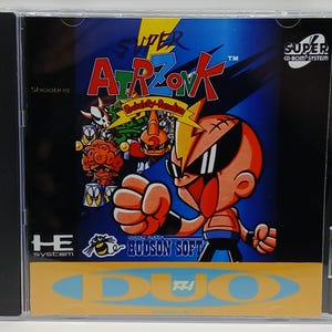 May include: A Super CD-ROM System video game case for the game "Super Air Zonk". The cover art features a cartoon character with sunglasses and a lightning bolt on his head, with other cartoon characters in the background. The case is in a clear plastic case.
