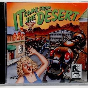 May include: A TurboGrafx 16 video game case for "It Came From The Desert." The cover art features a woman screaming, giant ants, a mushroom cloud, and the game's title in green and orange.
