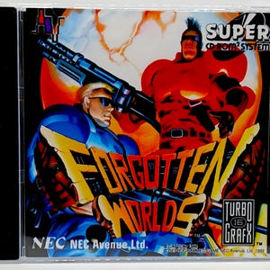 May include: A Super CD-ROM2 System game case for "Forgotten Worlds." The cover art features two muscular figures with weapons against a fiery backdrop. The game title is in yellow and orange, with the Turbo Grafx logo.