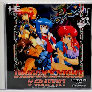 May include: A PC Engine game case featuring anime-style illustrations. The cover art showcases multiple female characters with vibrant hair colors, set against a dark background. The title "DRAGON KNIGHT & GRAFFITI!" is prominently displayed.