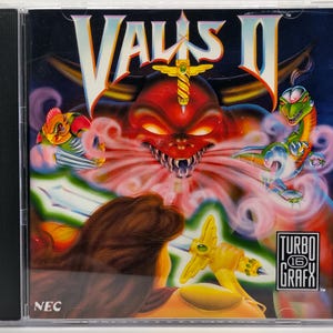 May include: Vallis II video game case. The cover art features a red demon with glowing eyes, a sword, and two fantasy creatures. The game is for the TurboGrafx 16 system. The case is in a black plastic jewel case.