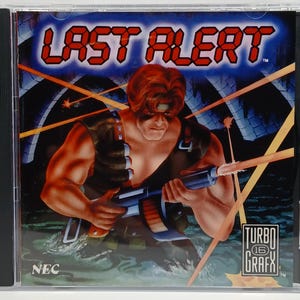 May include: A Last Alert TurboGrafx-16 video game case. The cover art features a muscular man holding a machine gun, with the title "LAST ALERT" in red and blue. The NEC and TurboGrafx-16 logos are visible.