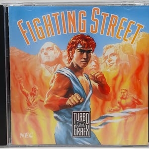 May include: A Fighting Street video game case. The cover art features a muscular man in a blue and orange outfit, with the text "FIGHTING STREET" in orange. The TurboGrafx-16 logo is visible.