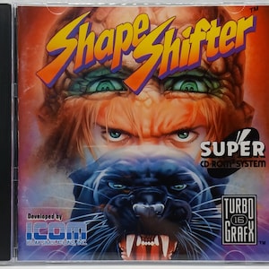 May include: A CD-ROM case for the video game "Shape Shifter." The cover art features a menacing face with glowing eyes, a panther, and the text "Shape Shifter" in yellow and purple. The "Super CD-ROM System" logo is visible.