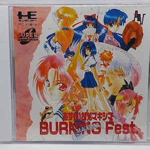 May include: A CD case with a pink background and a colorful anime illustration of characters from the game "Asuka 120% MAXIMA BURNING Fest."