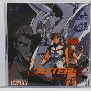 May include: A video game cartridge for the Sega Genesis console. The game is called "Vasteel 2" and features a futuristic robot and two characters. The game is set against a dark background with the text "Arcade CD-ROM" and "Super System" in the upper right corner.