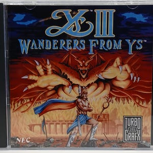 May include: A TurboGrafx-16 game case for "Ys III: Wanderers From Ys." The cover art features a warrior with a staff, a large red demon, and the game's title in blue and white. The background is a fiery scene.