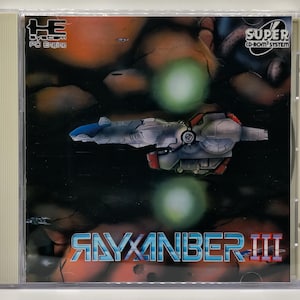 May include: A CD-ROM case featuring the game 'Rayxanber III'. The cover art depicts a futuristic spaceship in a dark space scene with green orbs and the game's title in blue and red. The case also has the 'Super CD-ROM² System' logo.