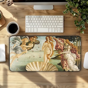 May include: Rectangular mousepad featuring a reproduction of Sandro Botticelli's "The Birth of Venus." The artwork depicts Venus emerging from a seashell, surrounded by figures and flowing fabrics. The mousepad has a black border and is on a wooden desk.