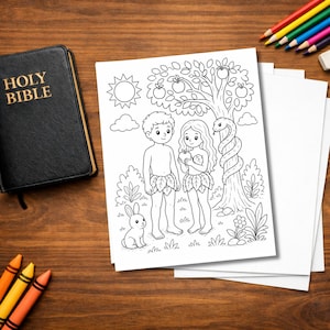 May include: A black leather-bound Holy Bible rests on a wooden surface next to a black and white illustration of Adam and Eve in the Garden of Eden. Colored pencils and crayons are scattered around the scene.