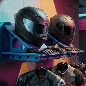 May include: Two black motorcycle helmets with visors displayed on blue wall-mounted shelves. Below, motorcycle jackets and pants hang on hangers. The scene includes a motorcycle and a tool chest.