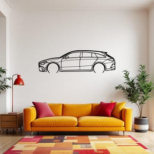 May include: A black line drawing of a car on a white wall above a yellow couch with red throw pillows. The car is a Mercedes-Benz.