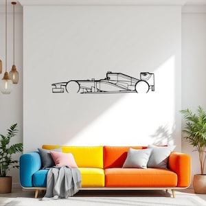 May include: Black metal wall art depicting a Formula 1 race car. The artwork is a side profile outline of the vehicle, mounted on a white wall above a colorful sofa. The car's wheels, chassis, and cockpit are clearly defined.