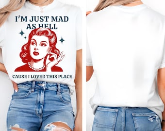 May include: White t-shirt with the text "I'M JUST MAD AS HELL CAUSE I LOVED THIS PLACE" and a red illustration of a woman. The word "white" is written in the top right corner. The back of the shirt is plain white.