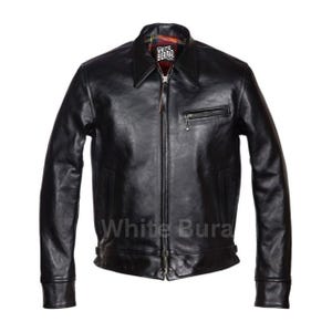 May include: A black leather jacket with a collared neckline and a front zipper closure. The jacket features a small zippered chest pocket and a plaid lining visible at the collar. The brand name "White Buraq" is printed on the front.