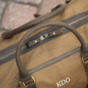 Zipper view of the brown Langston duffle bag