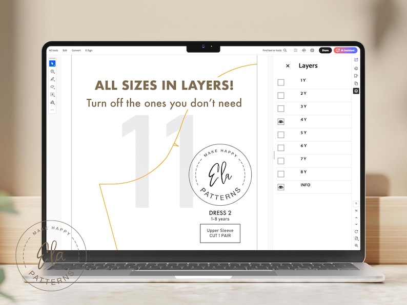 May include: A laptop screen displays a digital sewing pattern with the text "ALL SIZES IN LAYERS!" and "Ela Patterns." The pattern includes sizes from 1 to 8 years. The screen shows a dress pattern with an upper sleeve cut.