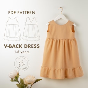 May include: A peach-colored V-back dress for ages 1-8 years hangs on a white hanger. The dress has a gathered bodice and a ruffled hem. The image also includes a line drawing of the dress and the text "V-BACK DRESS 1-8 years".